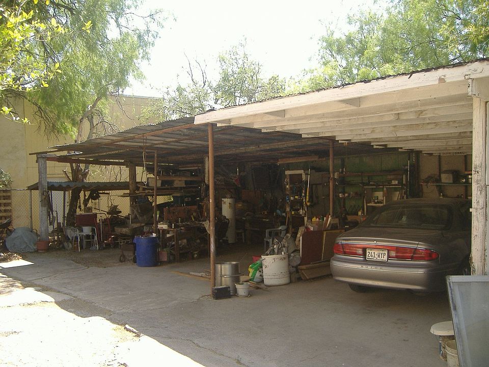 2 vehicle carport in back of house