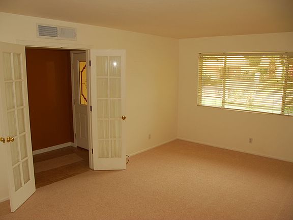 Den has double doors & bookshelves