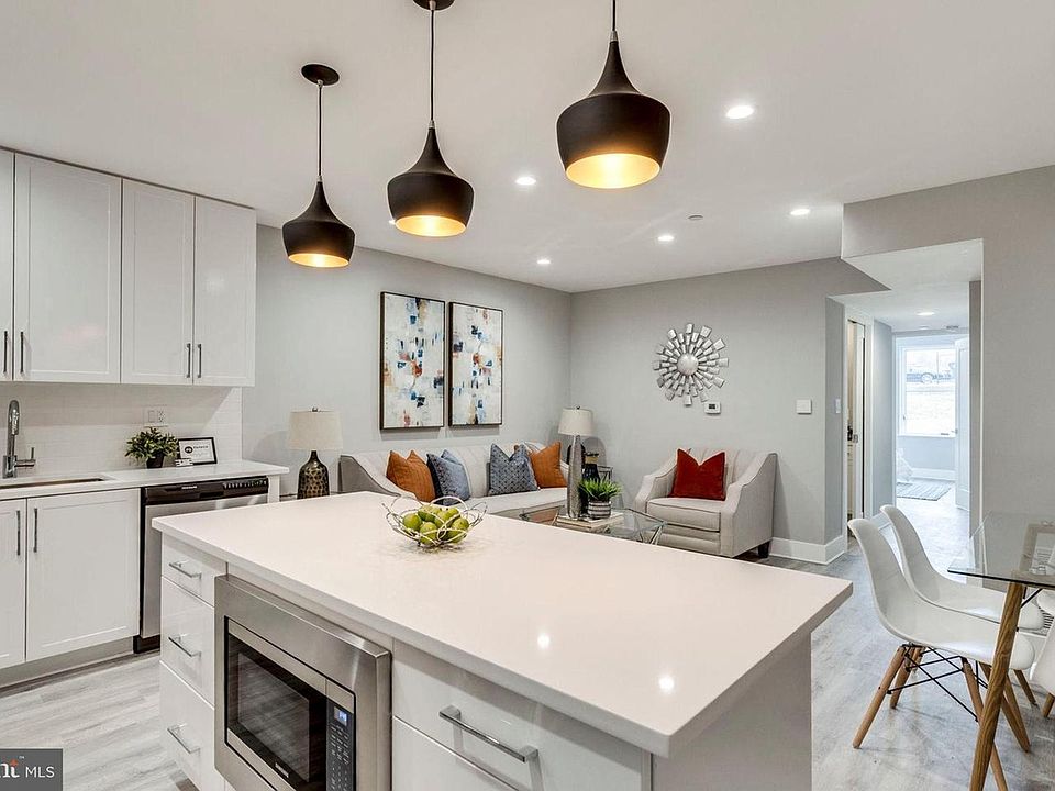 Spacious kitchen with pendant lighting and quartz countertops