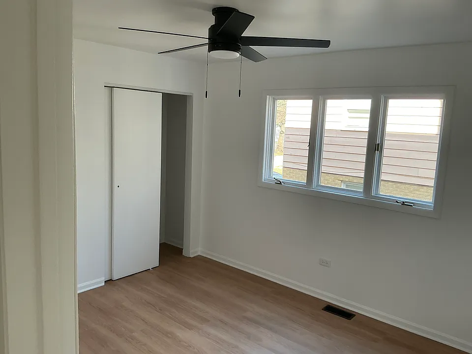 Second bedroom with a single closet. Black matted ceiling fan with LED lighting. Room dimensions 12 x 10.