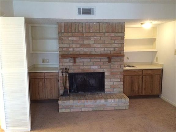 Living room with wood burning fireplace and bookcases
