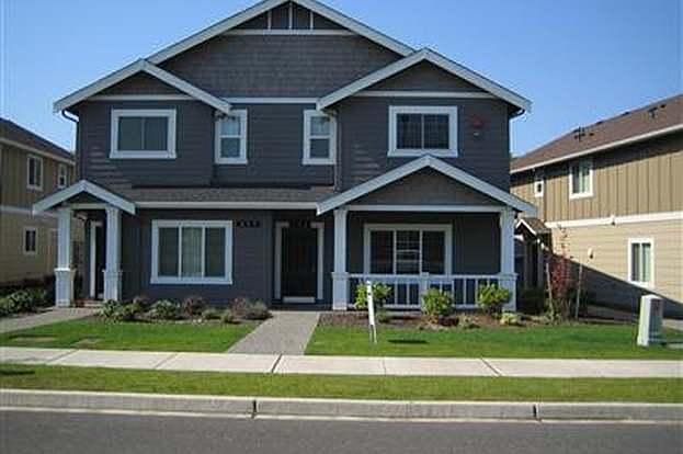 Large covered front sitting area & yard maintenance included