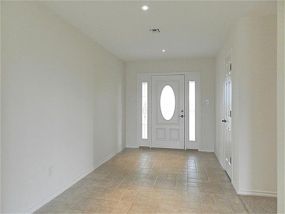 Wide foyer and subtle ambient lighting to greet guests.