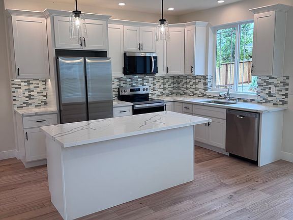 Kitchen located on main floor with stainless appliances and quartz countertops.
