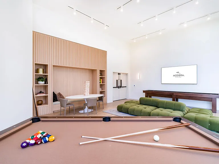 Enjoy game nights and gatherings in Modera Riverside's stylish game room with billiards and shuffleboard.