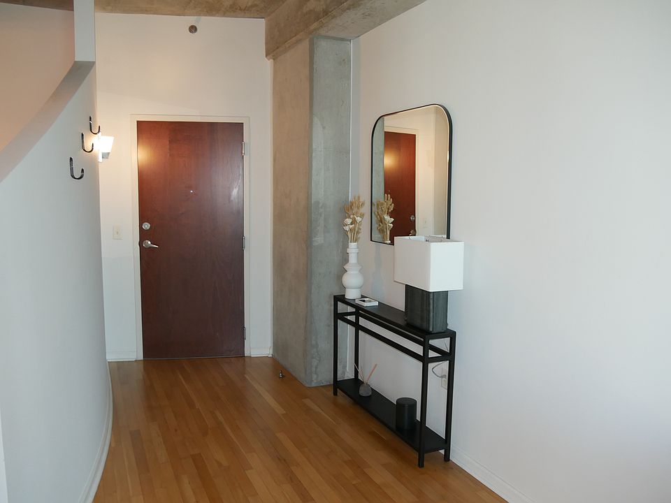 Entry table, lamp and mirror along with three jacket hooks.