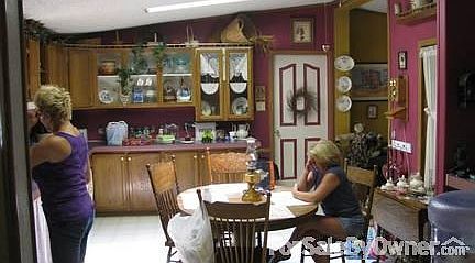 country kitchen with plenty of cabinets
						:
						Large kitchen includes pantry and breakfast bar with wet sink.