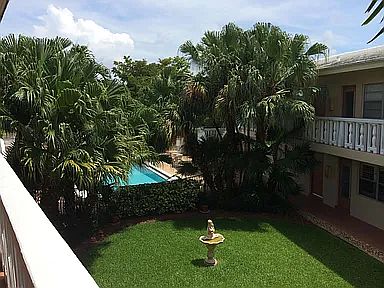 Upstairs looking towards the back of the courtyard with the pool and the Green space with million Dollar Plus homes align the street with homes that are backed up to Coral ridge country club, golf course