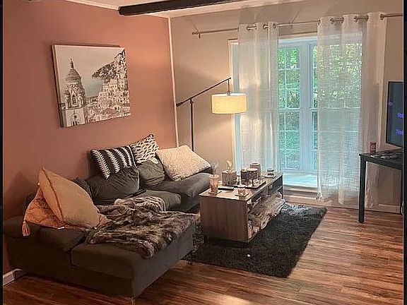 Living room. To the right is a larger area for additional furniture like a kitchen table.