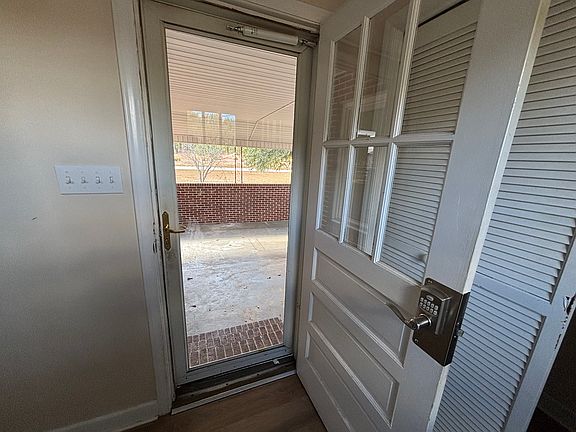 Keypad lock on carport door, laundry closet behind the door