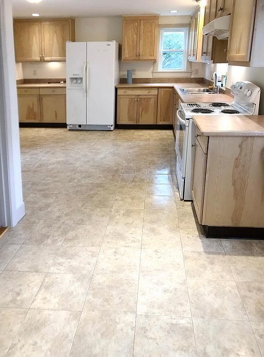 Modern open kitchen with plenty of storage and space for an eat-in table.