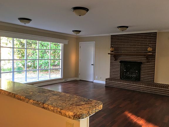 Large spacious den with gas fireplace and bay window