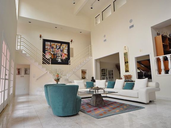 Grand living room another view, custom designed semi-circular marble steps to split staircase. art n