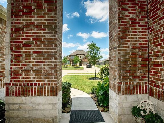 The covered front porch protects guests and packages from wind and weather.