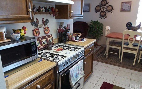 A super kitchen with plenty of storage, pantry area, and tile floors.