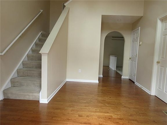 The entry welcomes you with gleaming wood laminate flooring. Open to half bath on right, laundry room is the second door on righ