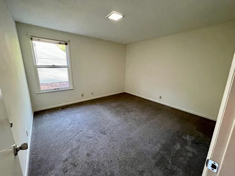 This is one of the 2 bedrooms on the main floor with a window and mini blinds to let in the natural light or for your privacy. The carpet is clean and was newly installed before the last renter.