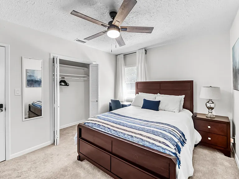 Queen sized bed, work station and closet