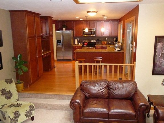 Gourmet kitchen with loads of custom cabinets, an eating nook and bar facing the kitchen.