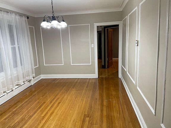 Dining Room. Open door bedroom. Ahead are the kitchen, 2 bedrooms, and bathroom.