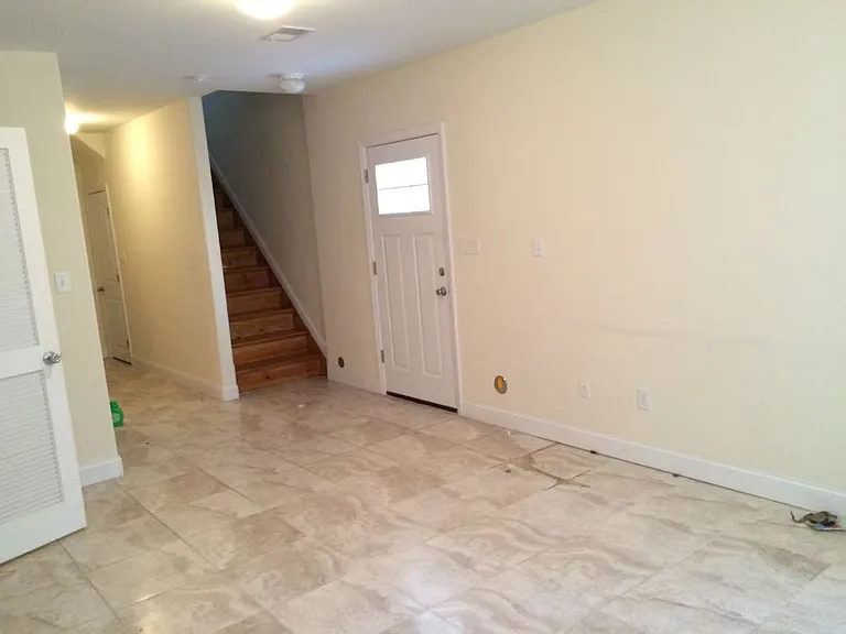 Ground floor living room, with stairs connecting upstairs, and seperate entrance