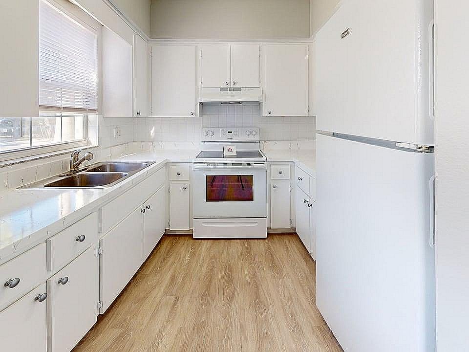 Bright, modern kitchen with sleek white cabinetry, spacious countertops, and inviting natural light.