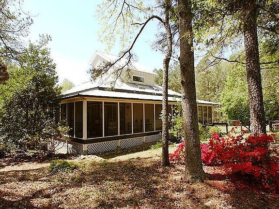 Side of the home shows the wrap around porches. Relax with you coffee!
