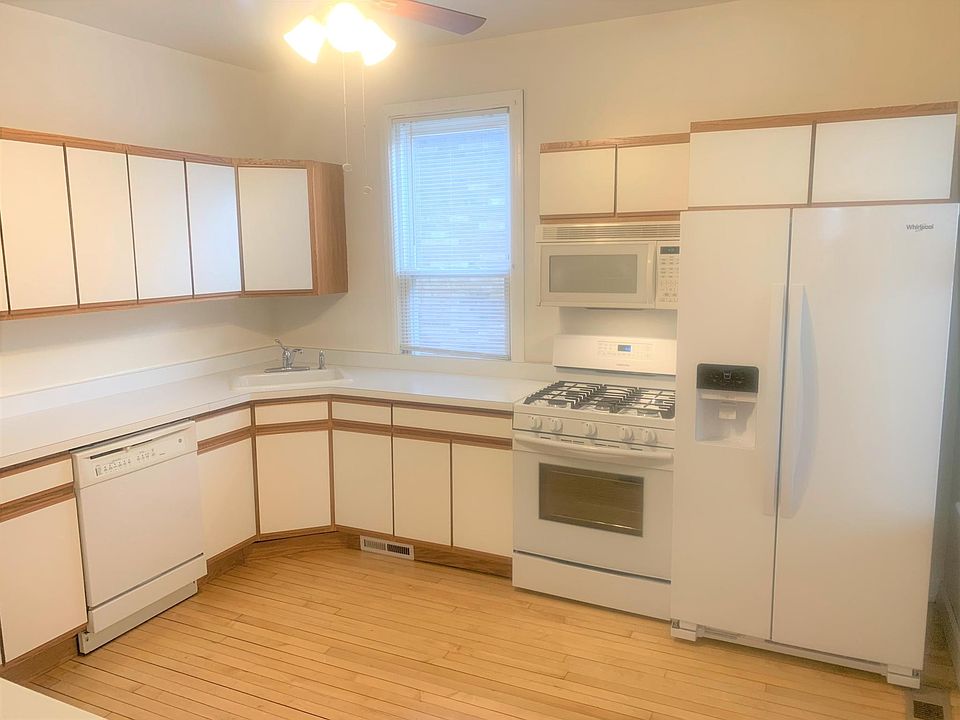 Updated kitchen with dishwasher, stove, microwave oven hood and refrigerator.