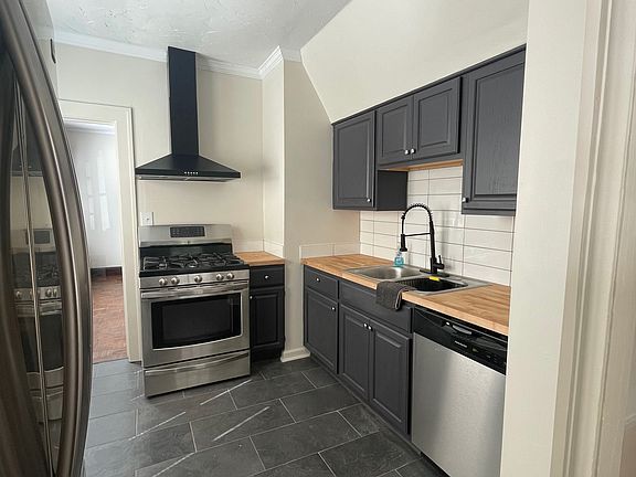 Kitchen w/ stainless steel appliances.