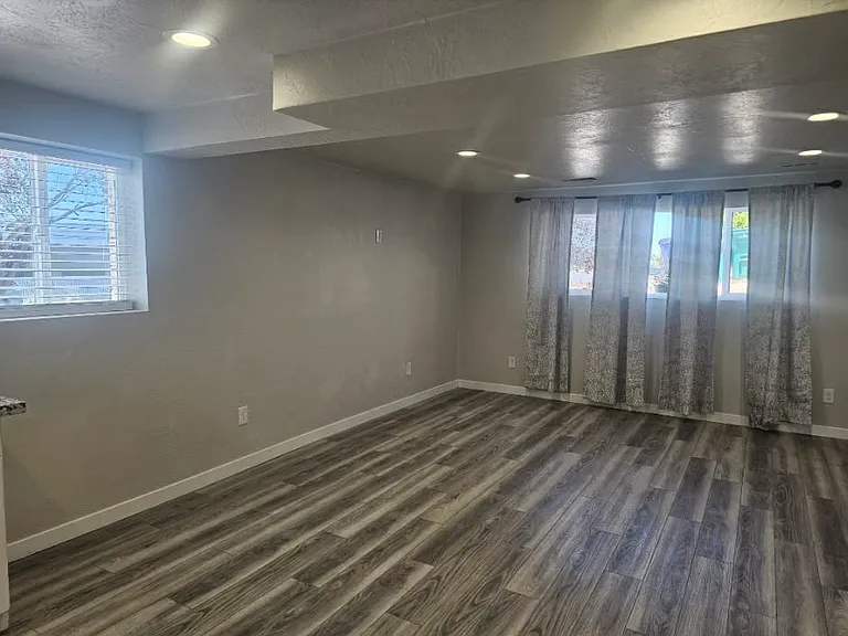 Living room with LVP flooring and great natural light.