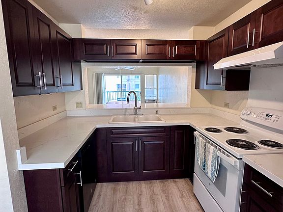 Newly updated kitchen cabinets counters and new stove.