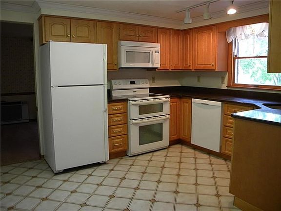 Bosch dishwasher, Maytag glass top electric stove and double oven, Maytag refrigerator and Whirlpool microwave.