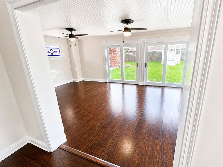 Sunroom with access to laundry room and downstairs bathroom.