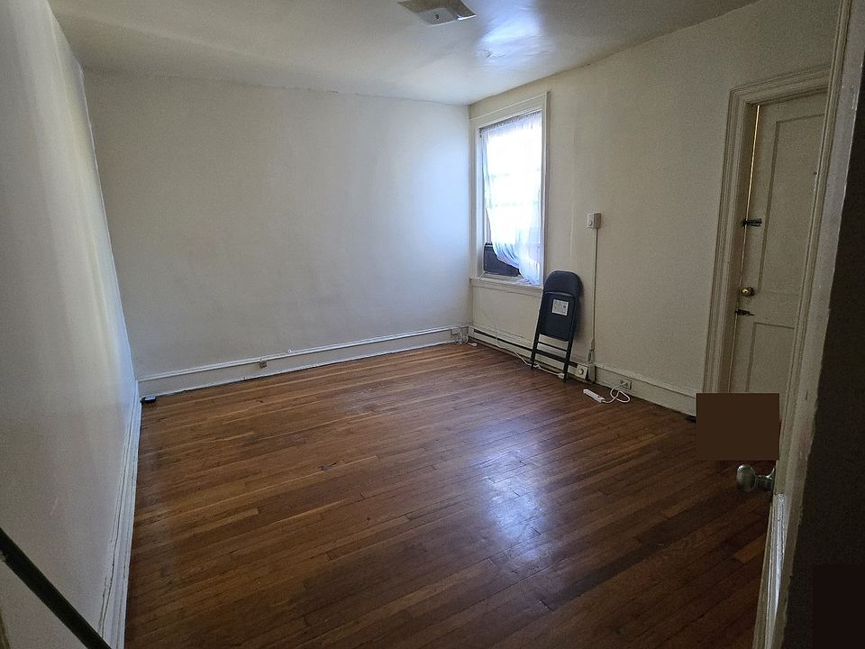 Spacious Master bedroom with original wood floors and direct access to bathroom