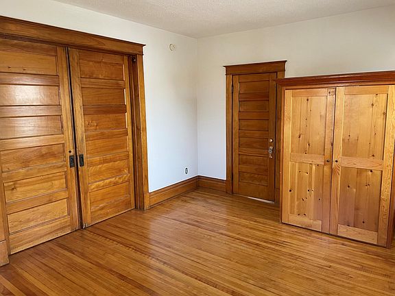 Bedroom 2 features library doors into living room. Includes wardrobe.