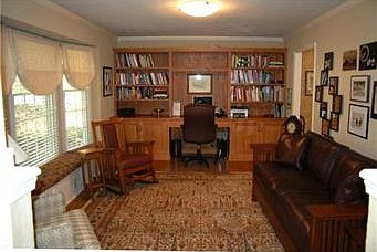 Living room with Hardwood Floor, Triple Bayed Window w/Window Seat and Window Coverings