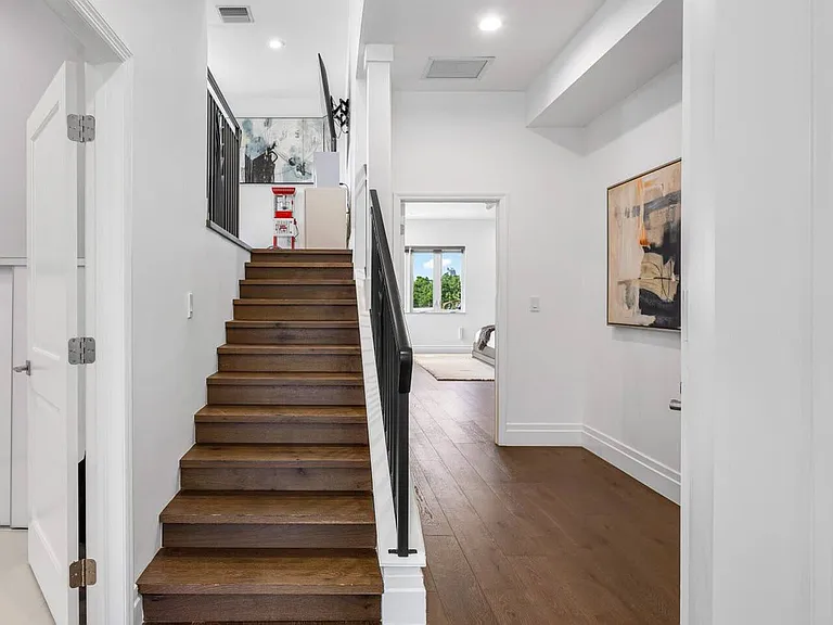 Step into refined elegance, where rich wood floors, modern artwork, and clean lines welcome you with understated sophistication.