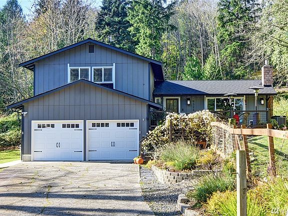 Front view with level driveway, new insulated garage doors with openers. Professionally landscaped and fenced side yard.