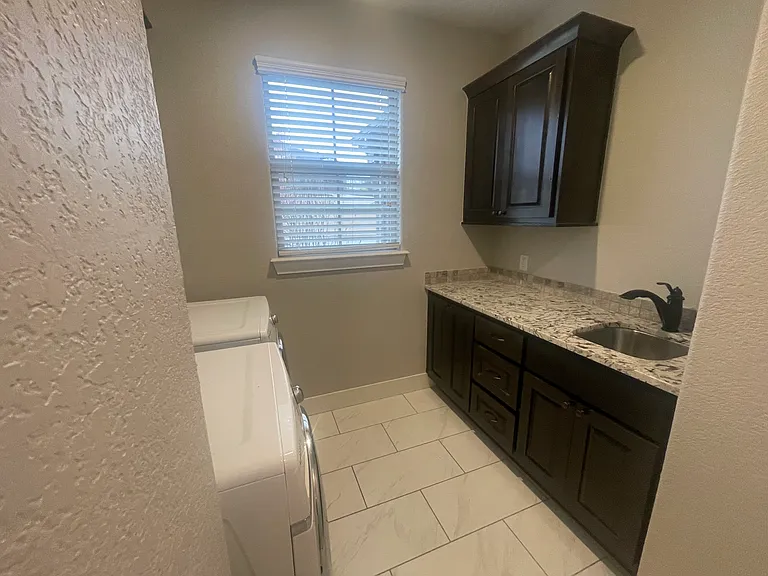 Laundry Room with storage, sink and linen closet
