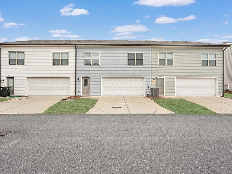 View of the exterior of the Fairburn home with a private driveway and attached garage.