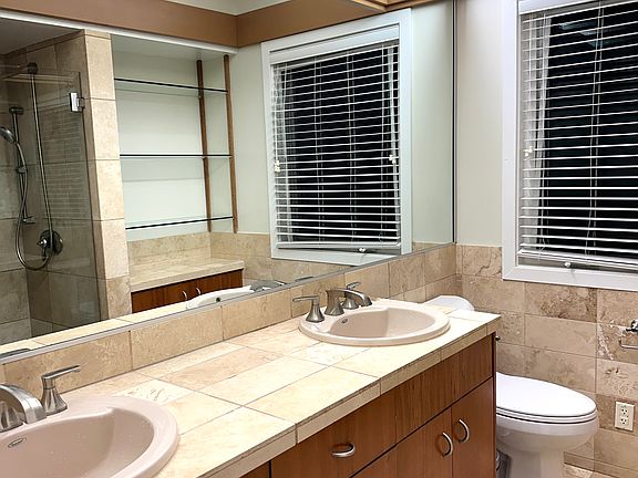 Master bedroom bathroom with double sink and stall shower