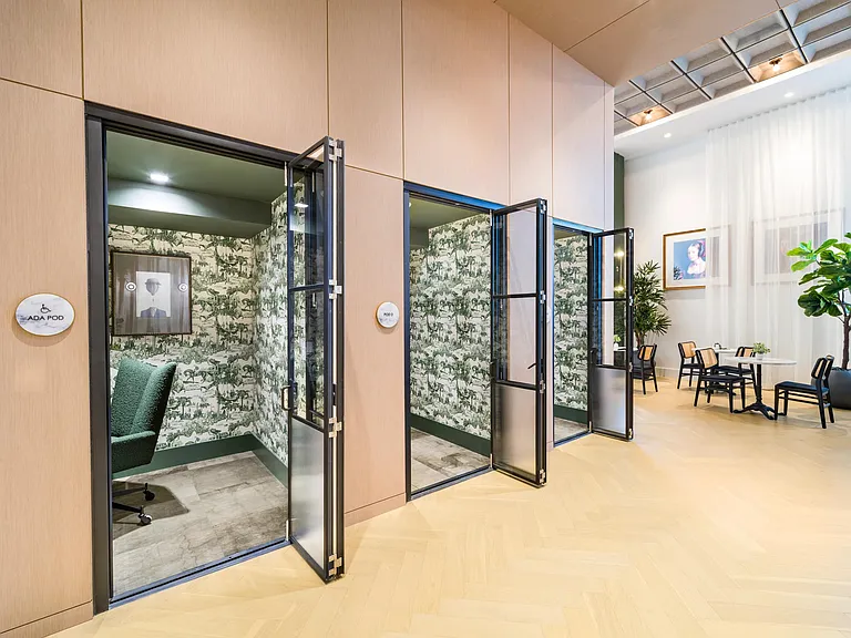 Private work pods with acoustic design and glass-front doors, offering focused space for calls, creative work, and quiet productivity.