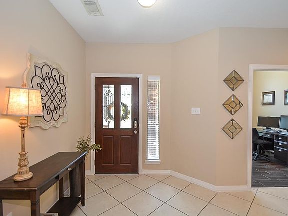 Mahogany  front door with Beveled glass inserts greet your guests.