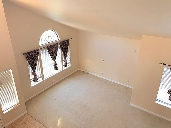 Looking down from upstairs into the high ceiling living room