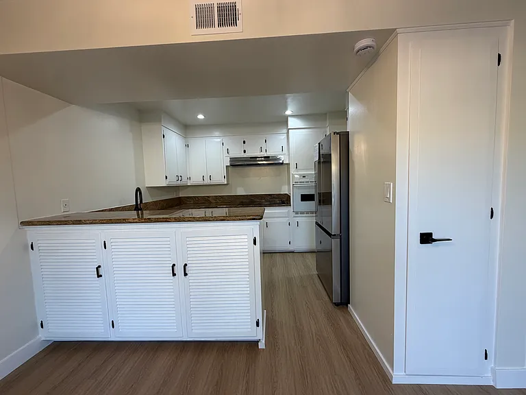 Kitchen with Granite Counter, Smooth Cooktop, & Large Stainless Steel Fridge