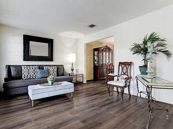 Large living room with laminate flooring.