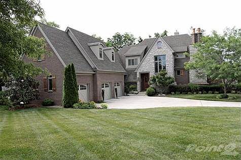 This home is made for entertaining family and friends! Spacious and open floor plan. Very unique exterior with covered portico leading to front entry, side entry garages with three separate entrances - each with their own key pads.  The garage area also has a utility sink. Beautifully landscaped.