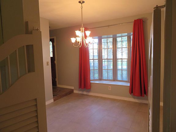 Formal dining room with new chandelier and bay window with b