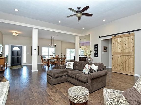 Family room looking to the front of the home. Barn door covers the mud room and utility area