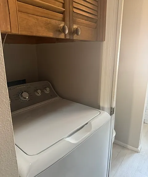 Laundry room with washer, dryer and cabinets